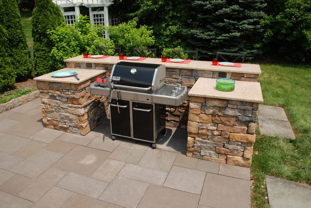 Serving and preparation spaces around the grill provide convenient preparation and eating areas outside.