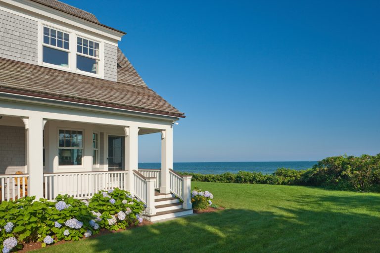 Side yard showing the side porch and view out to the ocean. Photo by Duckham Architecture