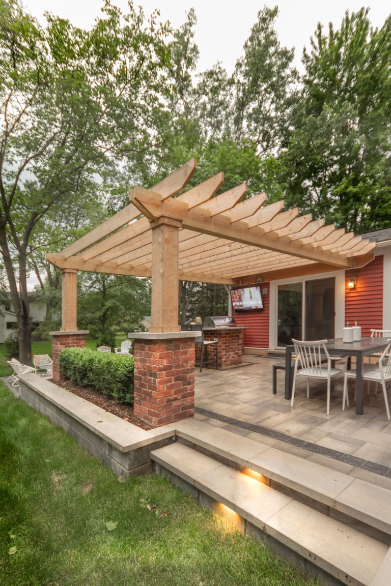 Small arts and crafts backyard brick patio kitchen photo in Detroit with a pergola