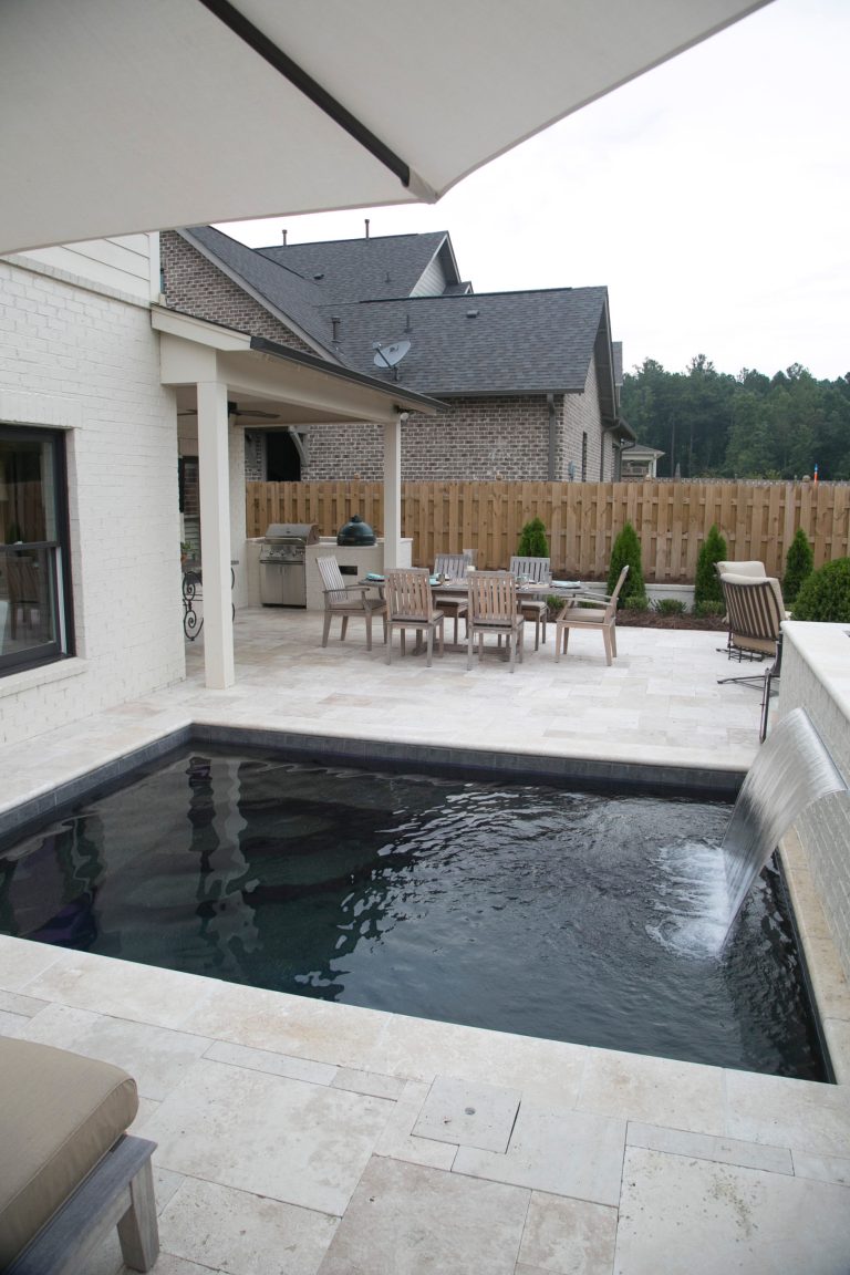 Small backyard stone and rectangular pool photo in Birmingham