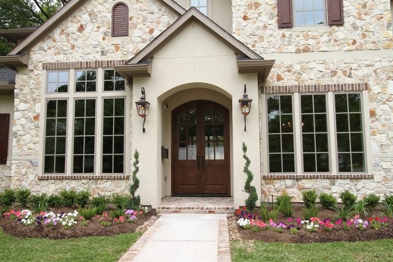 Small classic brick front porch idea in Houston with a roof extension by Trinity Estate Homes, Ltd. | Outdoor Photos | Porch | Landscaping | Landscape Design | Outdoor Living Space | Porch Design Ideas | Outdoor Living Space Ideas | Backyard Design