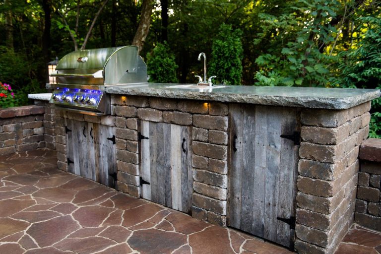 Small country backyard concrete paver patio kitchen photo in St Louis with no cover