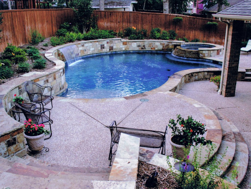 Small cozy pool with spa in sloped yard in Corinth, Texas designed by Mike Farley.