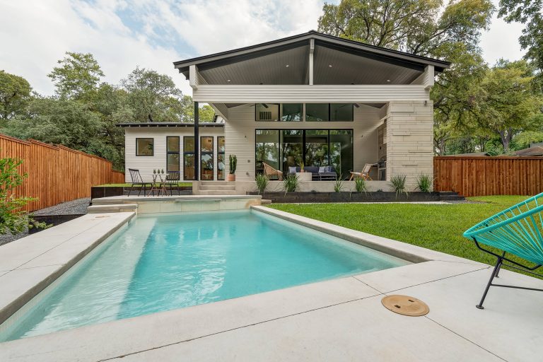 Small danish backyard concrete and rectangular pool photo in Austin