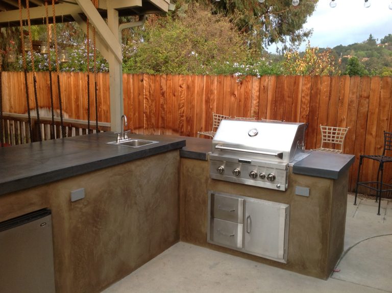 Small elegant backyard concrete paver patio kitchen photo in Los Angeles with a gazebo