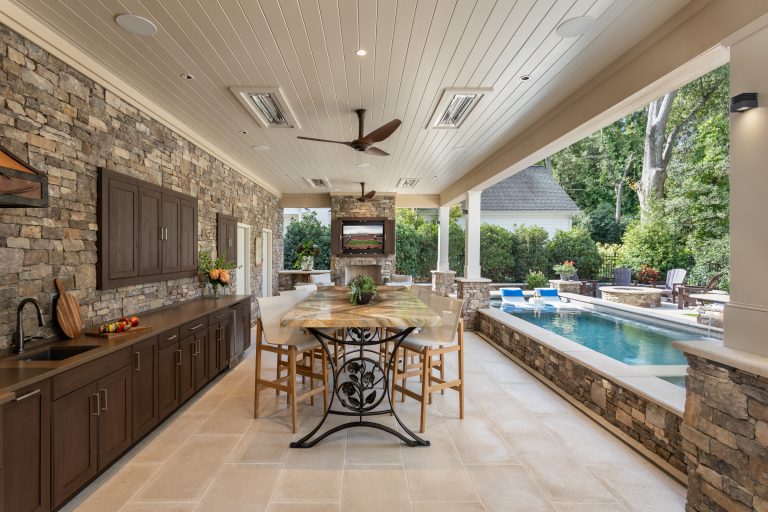 Small elegant backyard concrete paver patio kitchen photo in Other with a roof extension