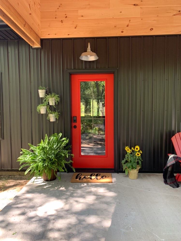 Small farmhouse concrete front porch photo in Tampa with a roof extension by HTM Lighting Solutions | Outdoor Photos | Porch | Landscaping | Landscape Design | Outdoor Living Space | Porch Design Ideas | Outdoor Living Space Ideas | Backyard Design