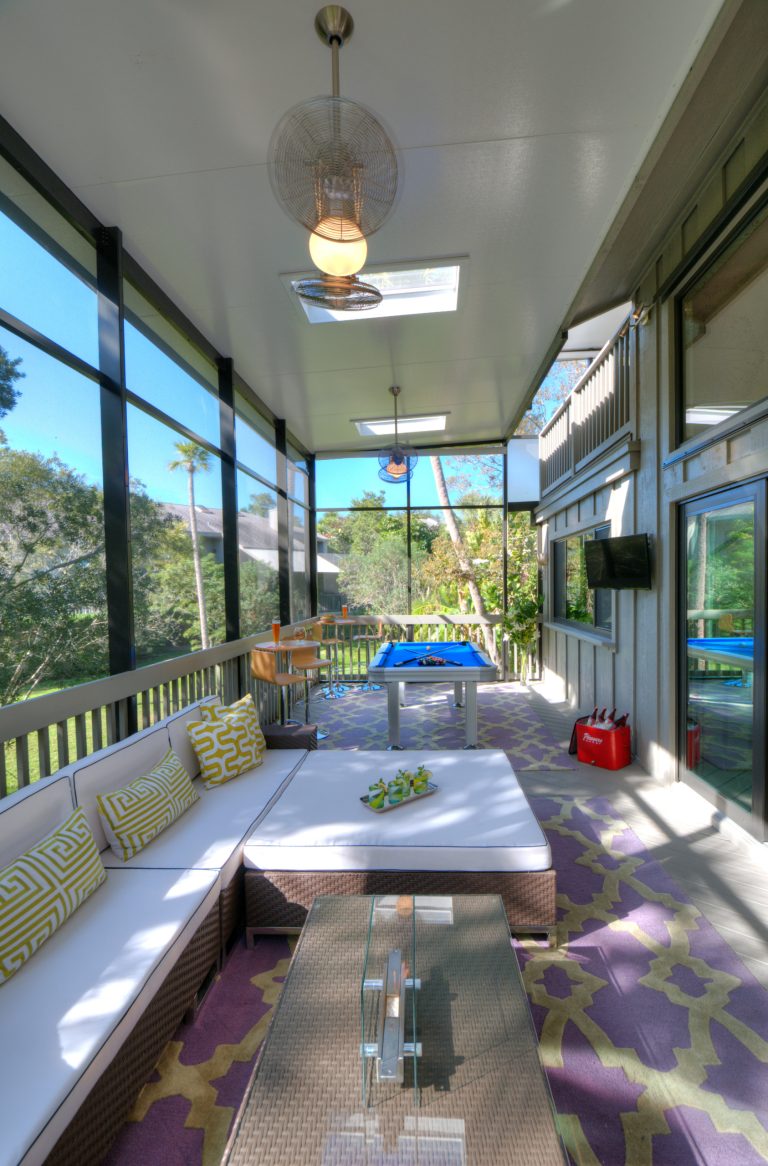 Small island style screened-in back porch photo in Tampa with decking and a roof extension by International Wood Floors | Outdoor Photos | Porch | Landscaping | Landscape Design | Outdoor Living Space | Porch Design Ideas | Outdoor Living Space Ideas | Backyard Design