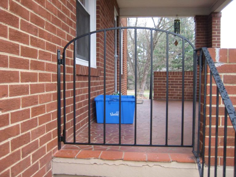 Small metal gate to keep the 4 legged kids on the porch and not running out the door into traffic.