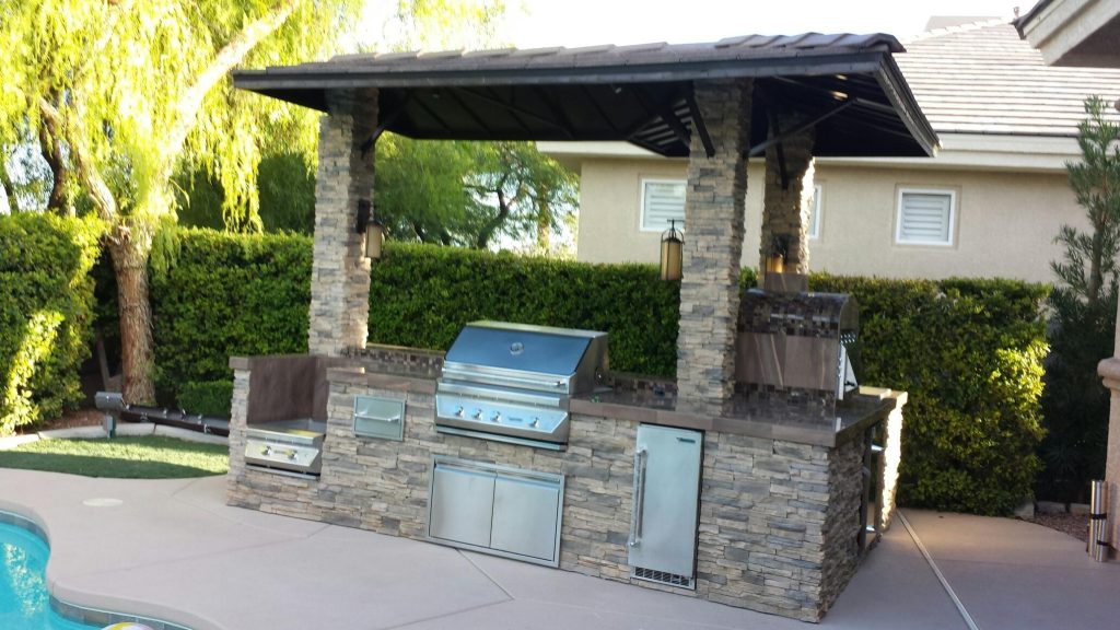 Small minimalist backyard concrete patio kitchen photo in Las Vegas with a gazebo
