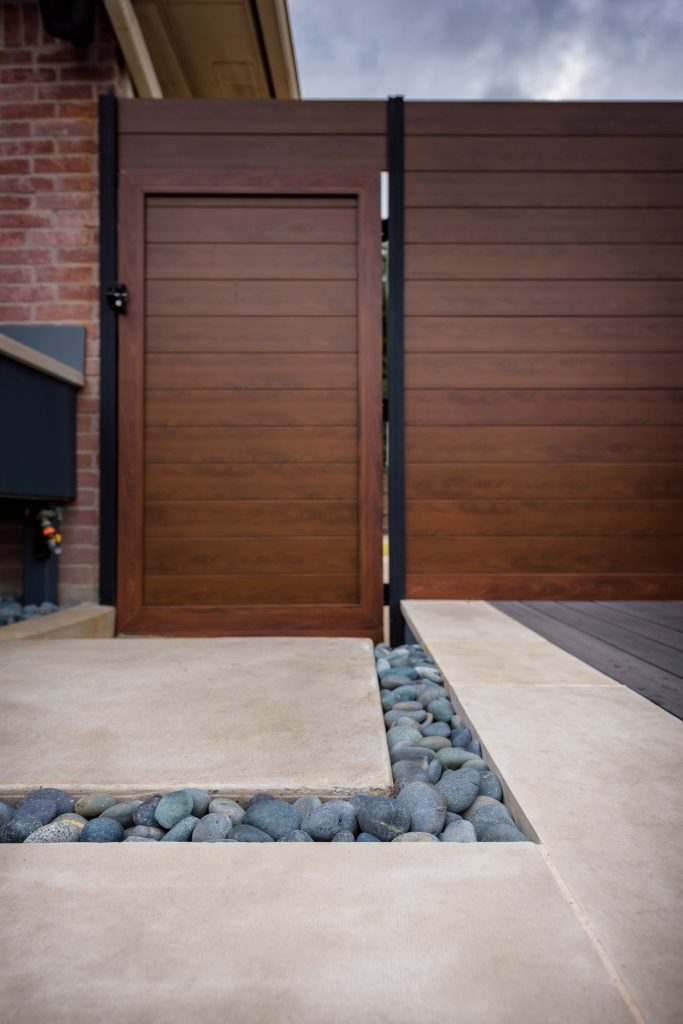 Small minimalist backyard concrete paver patio kitchen photo in Dallas with a roof extension