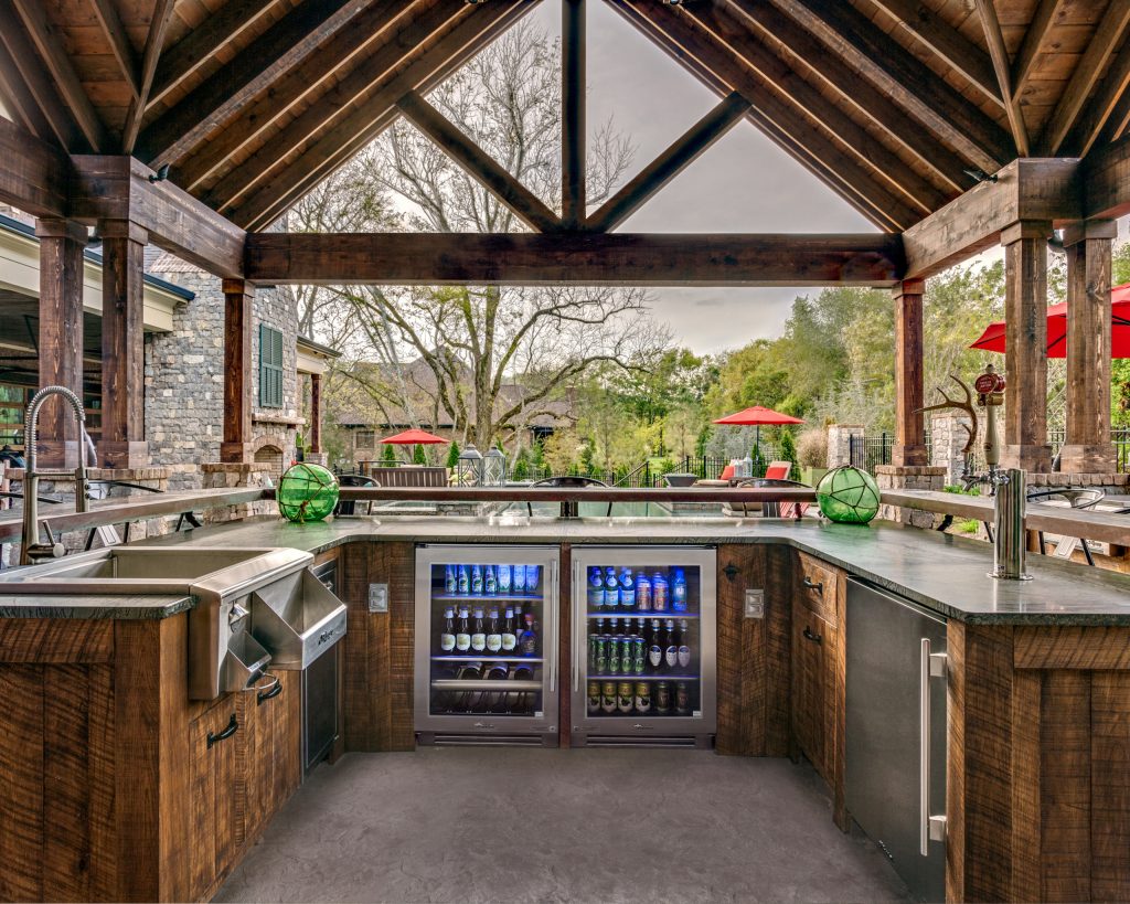 Small mountain style backyard concrete patio kitchen photo in Atlanta with a roof extension