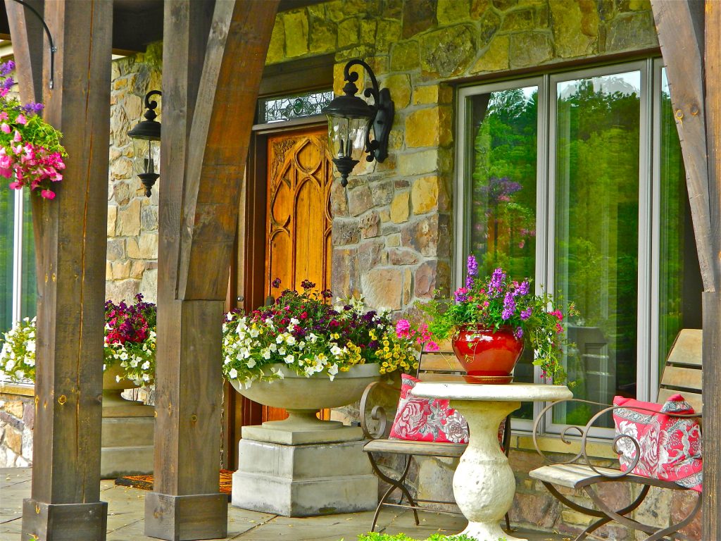 Small mountain style stamped concrete front porch idea in Other with a roof extension by Melissa Blackwood Homes & Interiors | Outdoor Photos | Porch | Landscaping | Landscape Design | Outdoor Living Space | Porch Design Ideas | Outdoor Living Space Ideas | Backyard Design