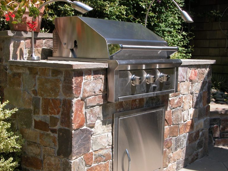 Small simple and elegant outdoor kitchen with grill and bluestone counter top. photo by Galen Fultz
