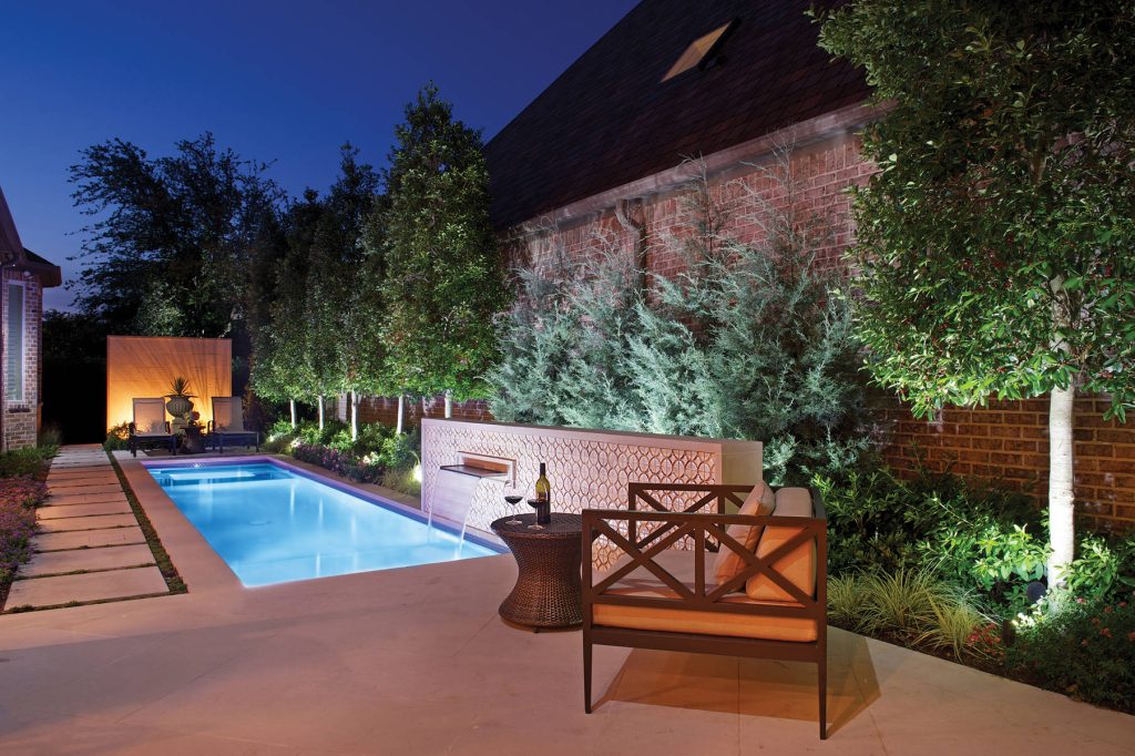 Small spaces can be the best. This pool and spa separated with a sheet of acrylic gives this pool an uninterrupted look. The limestone wall acts as a backdrop for the garden urn creating a focal piece of art