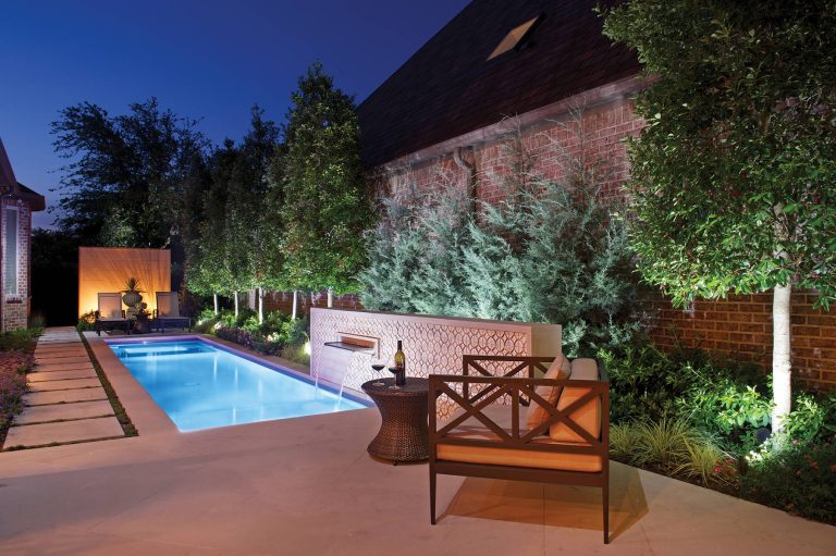 Small spaces can be the best. This pool and spa separated with a sheet of acrylic gives this pool an uninterrupted look. The limestone wall acts as a backdrop for the garden urn creating a focal piece of art