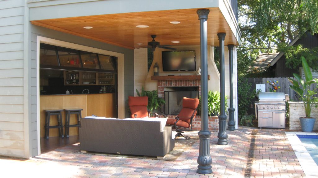 Small transitional backyard concrete paver patio kitchen photo in New Orleans with a roof extension