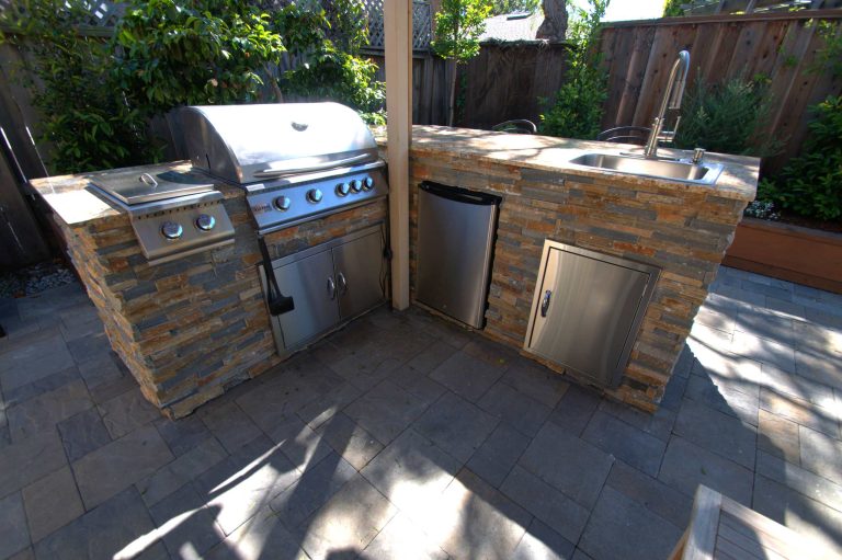 Small transitional backyard concrete paver patio kitchen photo in San Francisco with a pergola