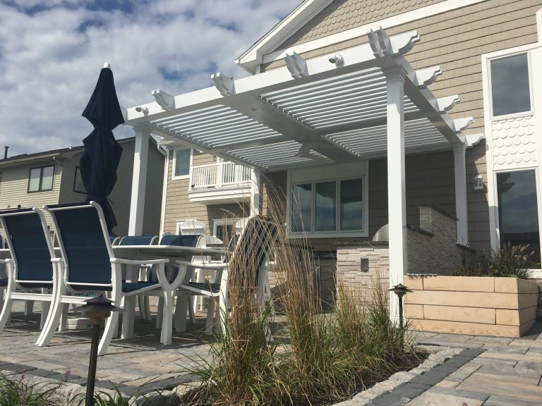 Smart Pergola System Installed over Outdoor Kitchen and Seating Area.