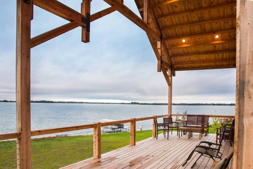 Spacious post and beam porch with hammer trusses.