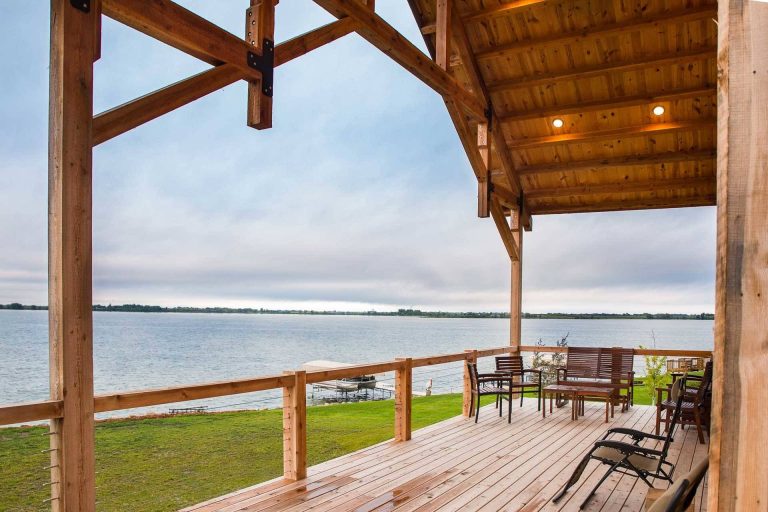 Spacious post and beam porch with hammer trusses.