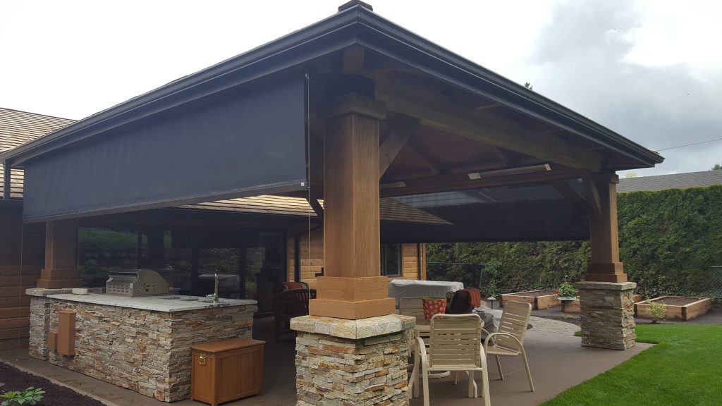 Stainless steel cable guided vertical drop screens help enclose an outdoor seating area