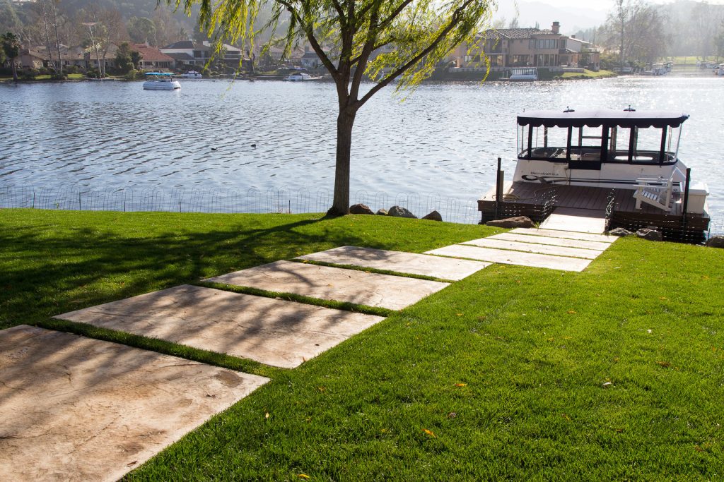Stamped Concrete slabs make a pathway to the home's dock. Photos by Jannus Studios