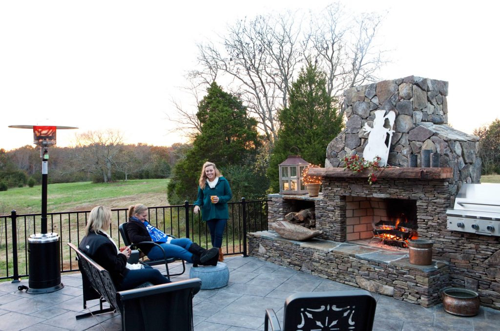 Stamped concrete patio with rock fireplace with outdoor cooking and beautiful views of the hunting reserve. Builder: C.H.I. Construction, Inc. (Roxboro, NC) by C.H.I. Construction, Inc. | Outdoor Photos | Porch | Landscaping | Landscape Design | Outdoor Living Space | Porch Design Ideas | Outdoor Living Space Ideas | Backyard Design