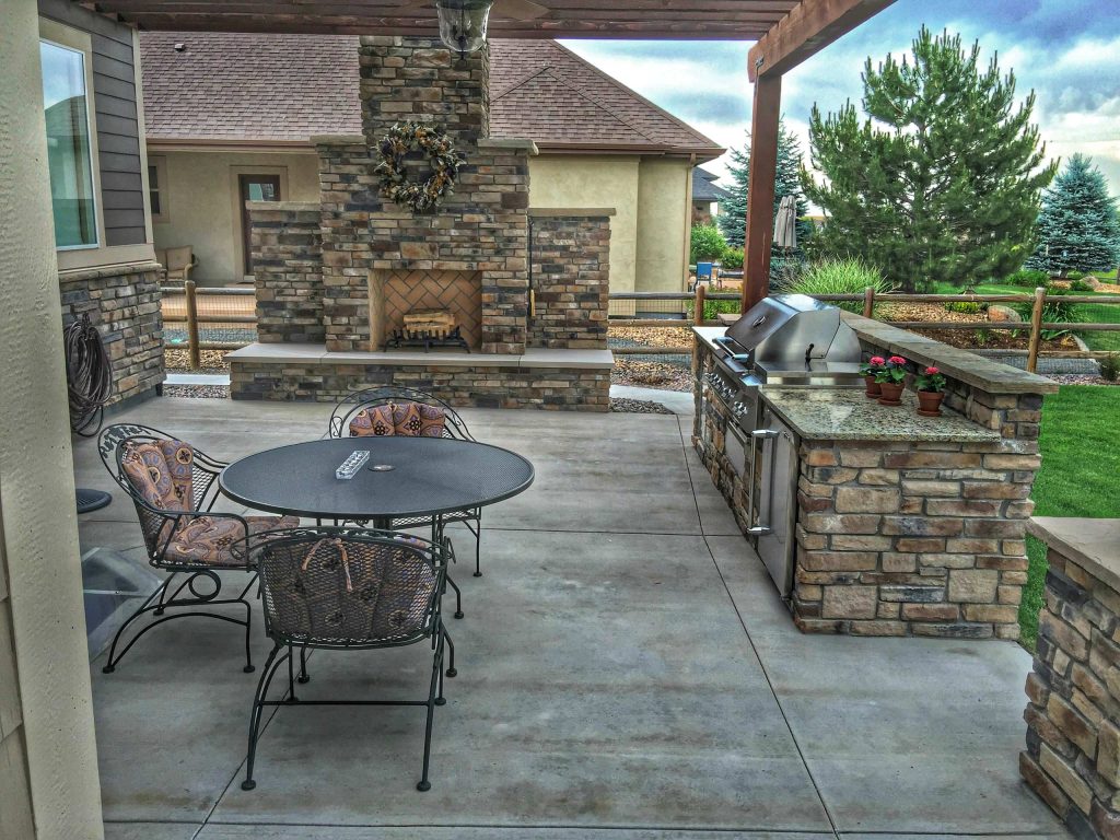 Stone Outdoor Kitchen with Twin Eagles Components and Real Wood Burning Outdoor Fireplace