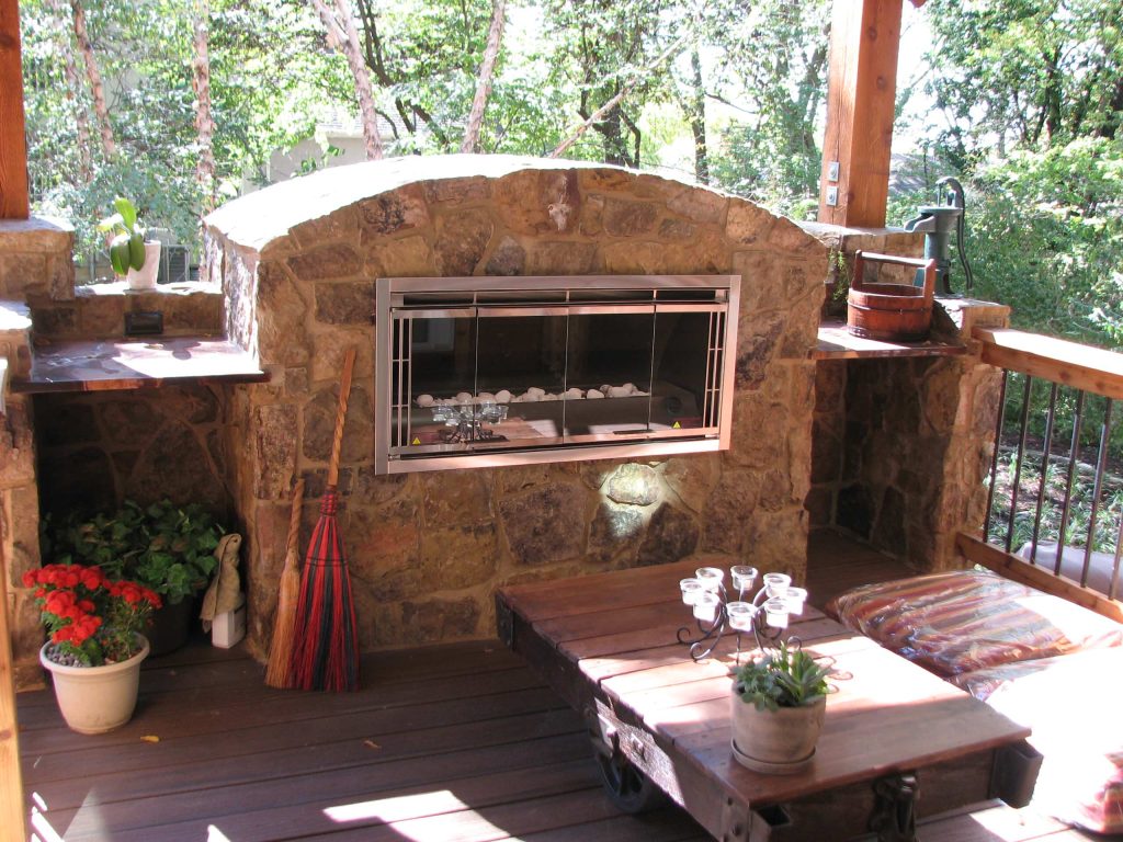Stone fireplace mass with built-in gas fireplace unit.