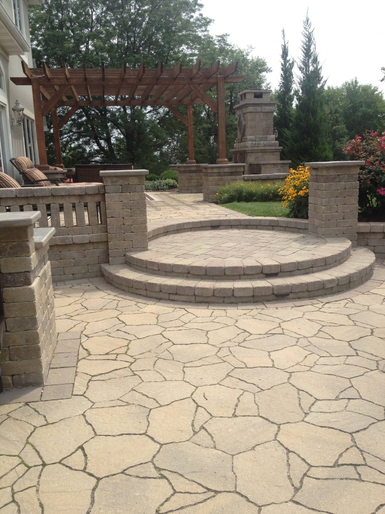 Stone patio kitchen photo in Kansas City