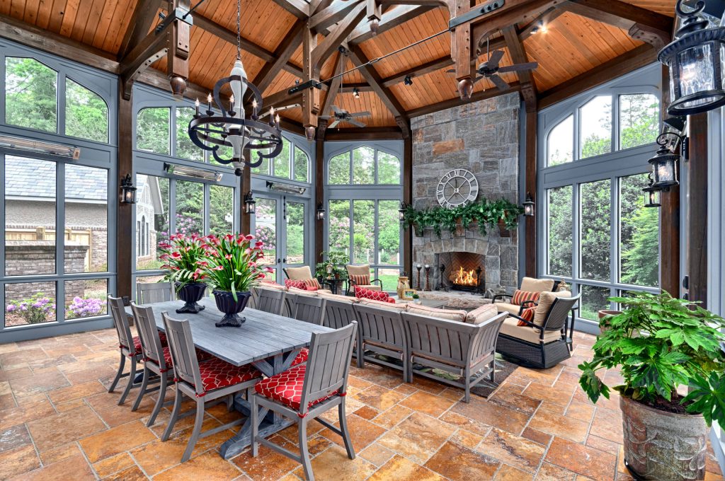 Stunning timber trusses define this space , huge masonry fireplace anchors one end of the porch, while a beautiful structural ridge skylight adds plenty of natural sunlight by BlueStone Construction, LLC | Outdoor Photos | Porch | Landscaping | Landscape Design | Outdoor Living Space | Porch Design Ideas | Outdoor Living Space Ideas | Backyard Design
