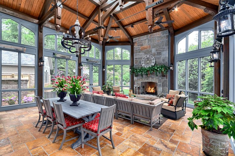 Stunning timber trusses define this space , huge masonry fireplace anchors one end of the porch, while a beautiful structural ridge skylight adds plenty of natural sunlight by BlueStone Construction, LLC | Outdoor Photos | Porch | Landscaping | Landscape Design | Outdoor Living Space | Porch Design Ideas | Outdoor Living Space Ideas | Backyard Design