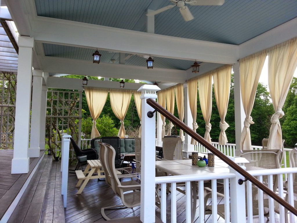 Summer living, dining, and lounge space. Design includes outdoor curtains to help define and make the most of the space throughout the hot summer days. by Christopher Collins | Outdoor Photos | Porch | Landscaping | Landscape Design | Outdoor Living Space | Porch Design Ideas | Outdoor Living Space Ideas | Backyard Design