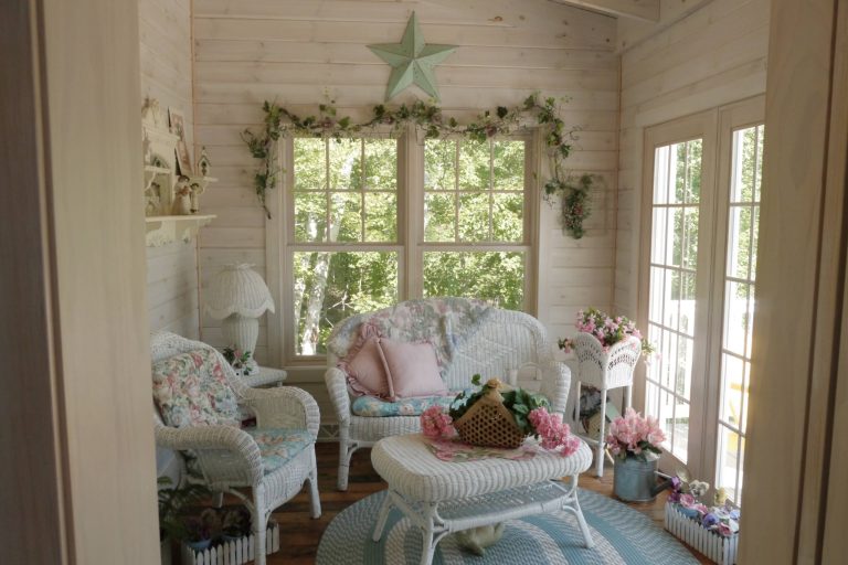 Sunroom interior featuring white washed Pine, large windows & patio door, and a cathedral ceiling with exposed beams