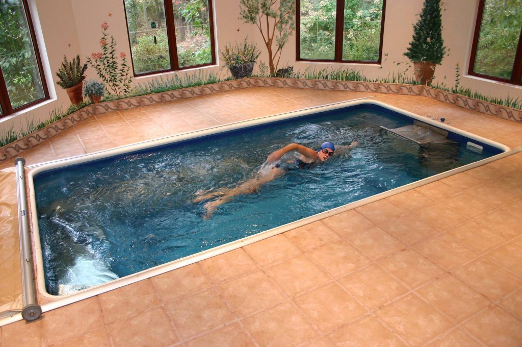 Swimming al fresco (sort of). With its clever murals, earthen tile, and garden view, this spacious swim room brings nature's glory into your private aquatic haven.