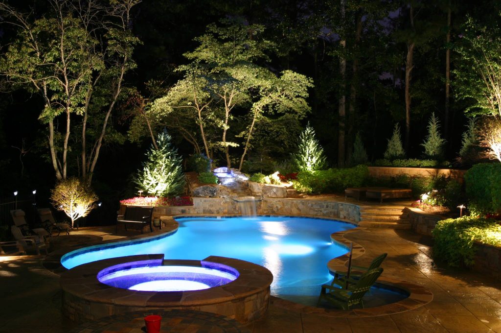 Swimming pool at night with color changing LED Lighting and landscape lighting. Phot taken by Mark Keightley, Owner of Artistic Landscapes