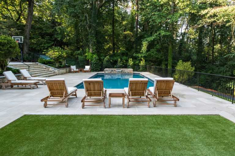 Synthetic turf breaks up the limestone pool deck.