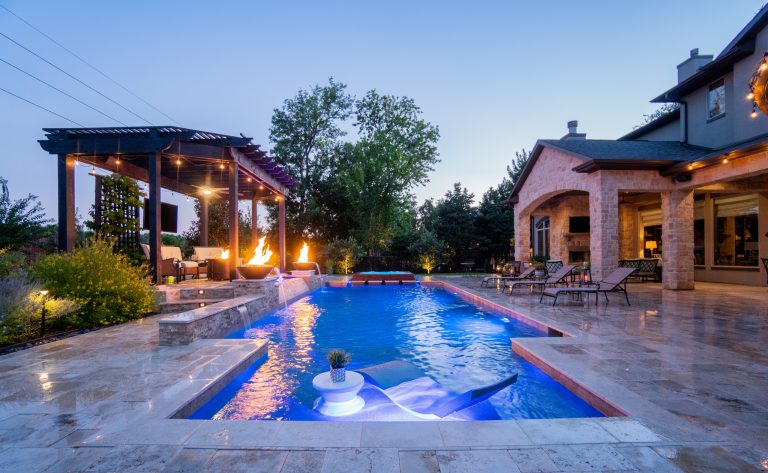 Talk about a gorgeous TBS...a Total Backyard Solution! Pool & spa combination with fire and water features, pergola seating area, outdoor kitchen area, and tanning ledge for the Ledge Lounger! Stunning travertine decking in Versaille pattern, ledger stone on the raised wall features, LED bubblers, glass tile all around the spa creates a backyard staycation you never want to leave! Ready for yours?