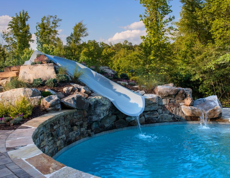Tennessee flagstone and field stone boulders create the raised area for the water slide.