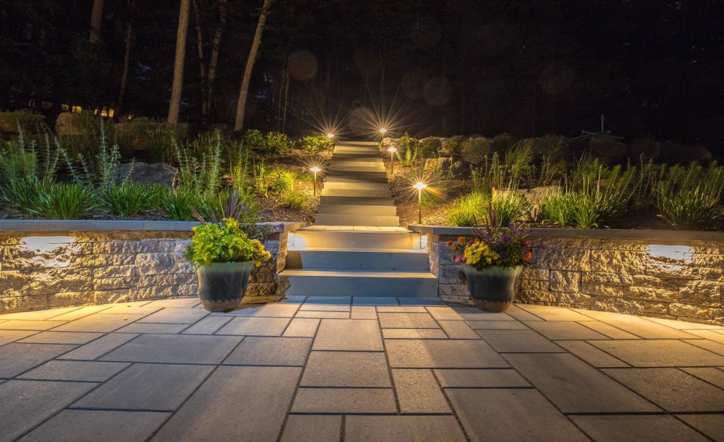 Terraced backyard, complete with Techo-Bloc patio, pergola, landscape lighting and flowing landscape!