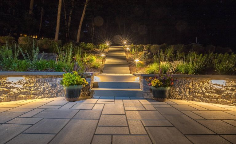 Terraced backyard, complete with Techo-Bloc patio, pergola, landscape lighting and flowing landscape!