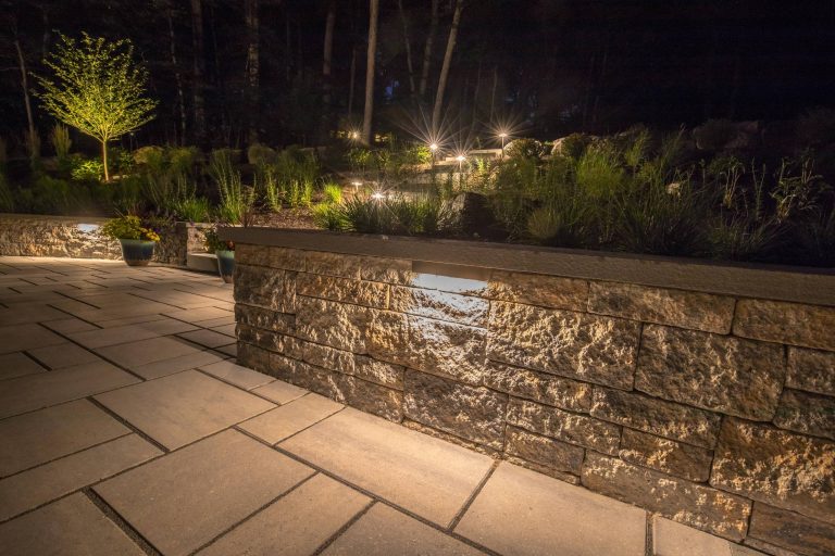 Terraced backyard, complete with Techo-Bloc patio, pergola, landscape lighting and flowing landscape!
