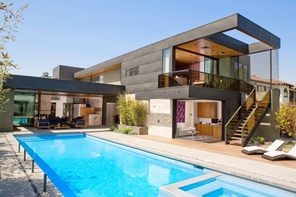 The L-shaped layout envelopes the pool area to create an indoor-outdoor space.