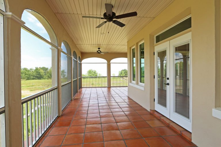 The Spanish Colonial home incorporates this fantastic screened wrap around porch, with terra-cotta tile flooring and 4 entrances from the inside the house by J&J Building | Outdoor Photos | Porch | Landscaping | Landscape Design | Outdoor Living Space | Porch Design Ideas | Outdoor Living Space Ideas | Backyard Design