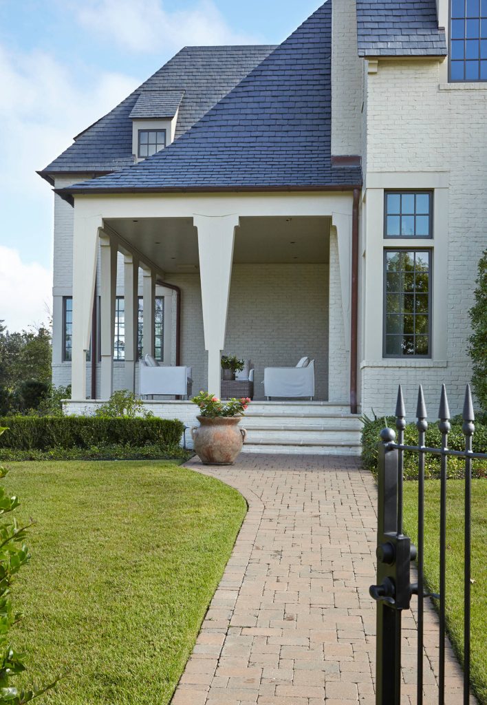 The architect wanted to take advantage of this corner lot but making the entryway on the corner as well. The front door lies just inside this side porch. by Windstone Partners | Outdoor Photos | Porch | Landscaping | Landscape Design | Outdoor Living Space | Porch Design Ideas | Outdoor Living Space Ideas | Backyard Design