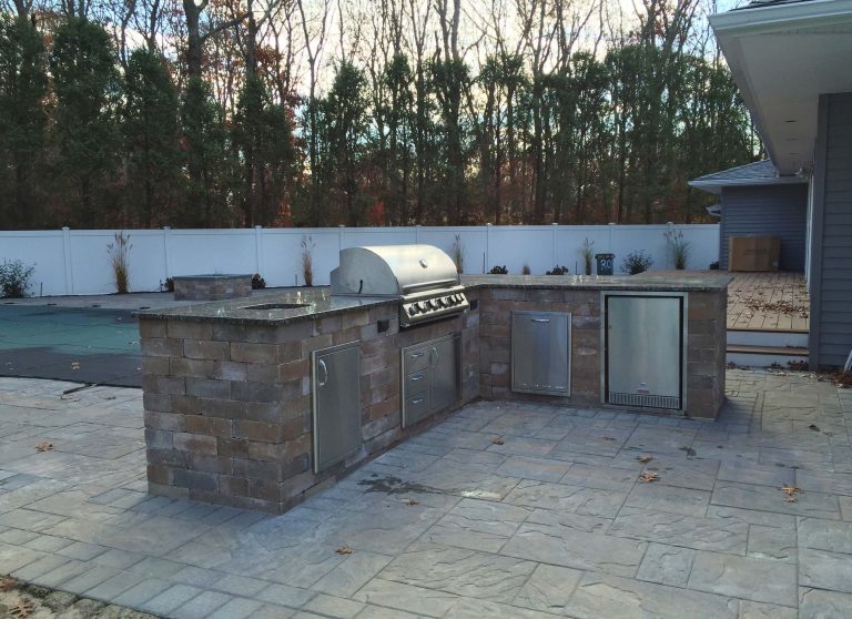 The backyard outdoor living space renovation included all new fencing, new back landscape, pool patio, sheer descent waterfall into pool, outdoor shower, outdoor kitchen, & outdoor fire pit - to name a few!