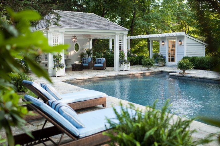 The cabana and adjacent changing area create just the right about of built environment around an elegant pool.