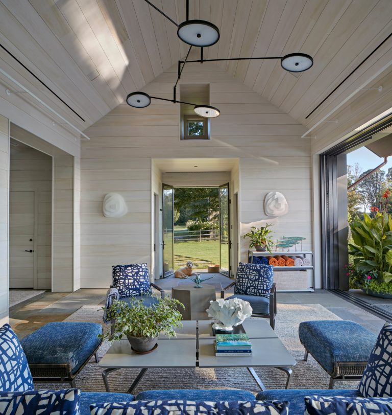 The clean, simple interior is contrasted with playful light fixtures, furnishings and fabrics. Robert Benson Photography.