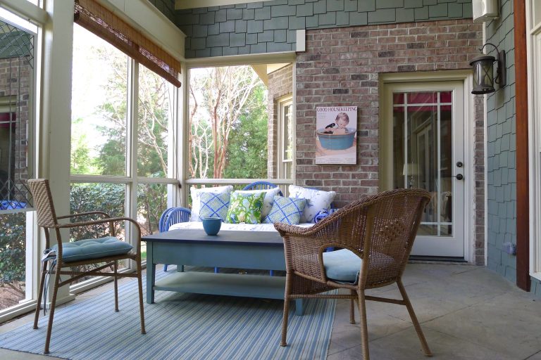 The cottage-striped rug from Dash & Albert adds a comfortable feel to my screened porch. It also separates the dining and conversation areas.